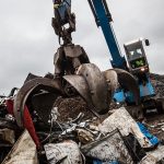 Grab in action in a scrap yard